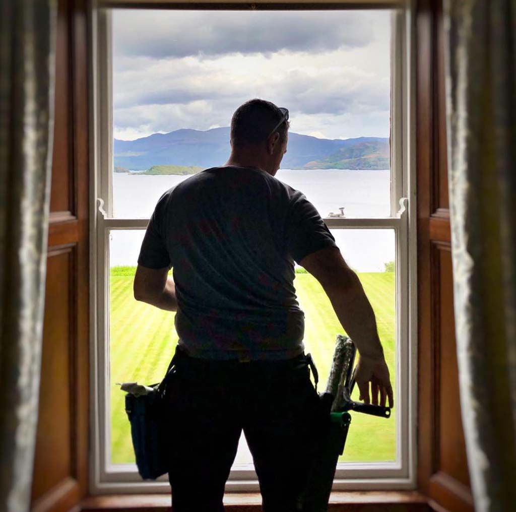Tim Beeston Cleaning at work, reflected in a freshly cleaned window