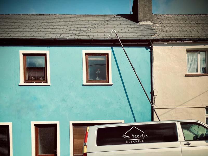 Gutter vacuum pole reaching up to a roofline in Killarney