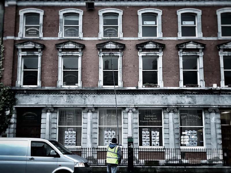 Window cleaner working on a multi-storey commercial building